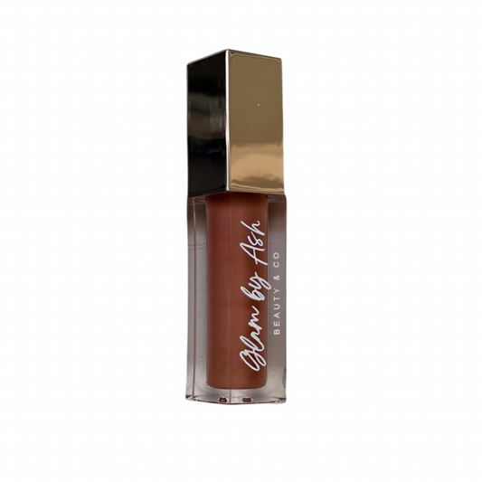 Lipstick with gold cap and clear casing on a white background